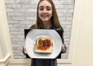 Devyn Callahan  pictured with her painting, Jelly Spread Toast.